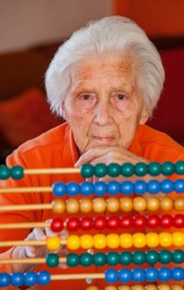 Senior citizen reckons with a slide rule at home