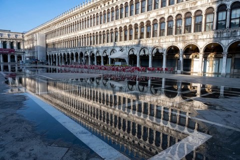 Reflection of the procurations at Acqua alta on St. Mark's Square