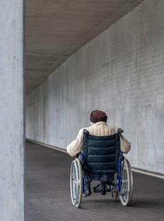 Senior citizen in a wheelchair in an underpass