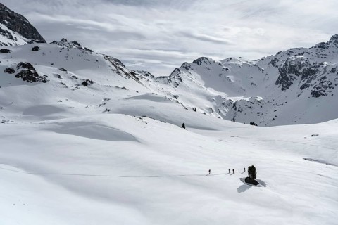 Ski tourers cross a flat slope