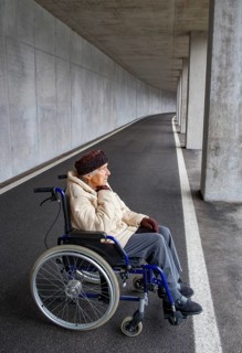 Senior citizen in a wheelchair in an underpass
