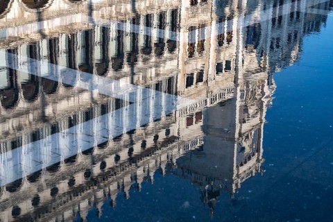 Reflection of the procurations at Acqua alta on St. Mark's Square