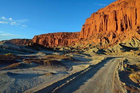Track in front of a red rock face
