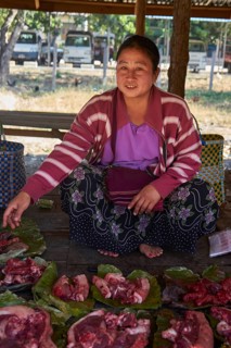 Market woman with pork