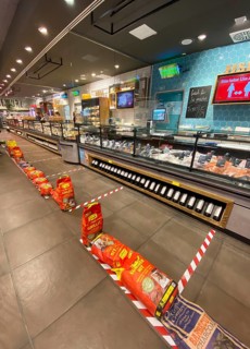 Barriers in supermarket for social distancing at fish counter