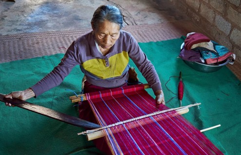 Woman weaving traditional patterns