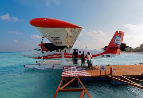 Passengers boarding seaplane De Havilland Canada DHC-6 Twin Otter of Maldivian Airlines