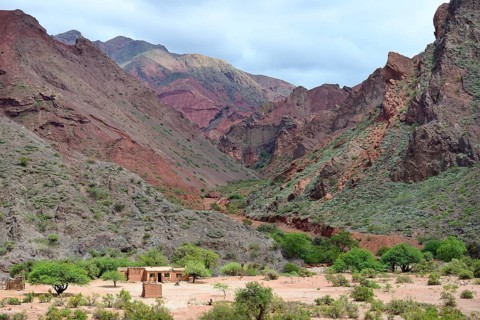 Lonely house in front of barren mountains