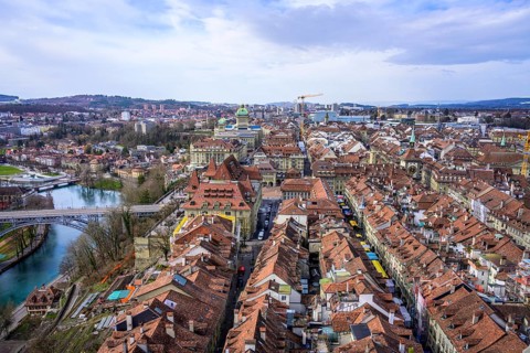 View from Bern Cathedral to the red tiled roofs of the houses in the historic city centre of the old town and river Aare