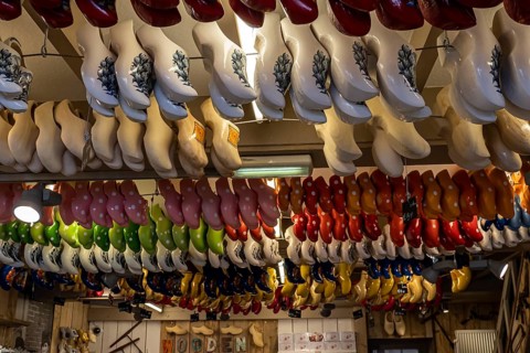 Traditionally colourfully painted Dutch clogs hanging from the ceiling in a clogs workshop