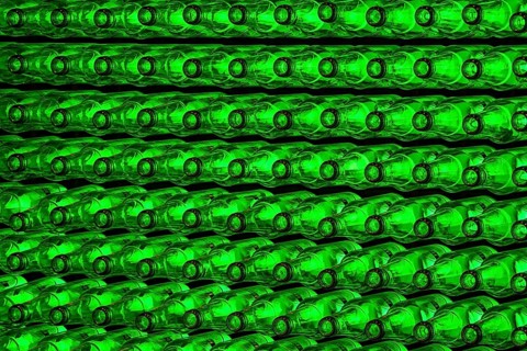 Empty green beer bottles on the conveyor belt