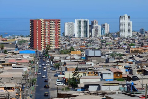Typical simple residential buildings in front of skyscrapers