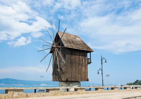 Wooden windmill and monument near historical centre of the town Nesebar