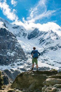 Mountaineer stands on rocks