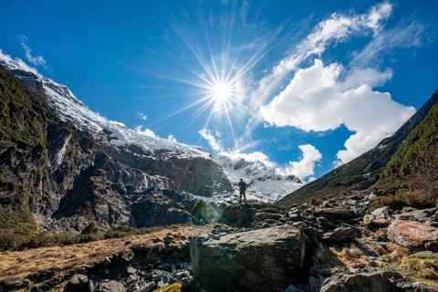 Mountaineer stands on rocks