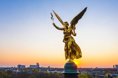 Golden angel of peace at sunrise