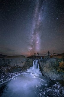 Orchon waterfall at night with starry sky and Milky Way