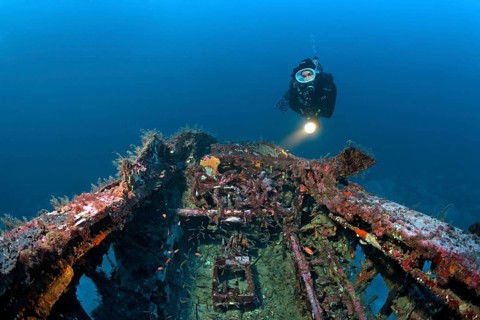 Diver views cockpit at aircraft wreck