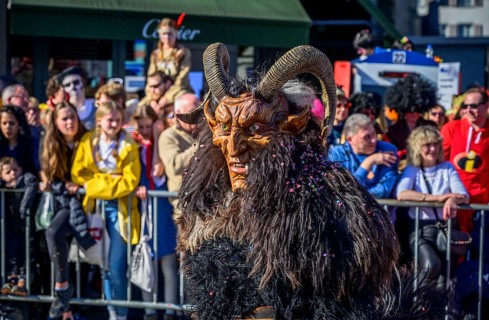 Masked person with devil mask, Carnival parade of the Wey Guild on Rose Monday