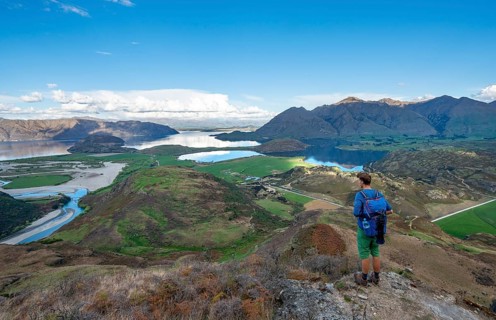 Hiker on the hiking trail to Rocky Peak, views of Wanaka Lake and mountains