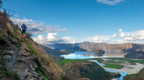 Hiker on the hiking trail to Rocky Peak, views of Wanaka Lake and mountains