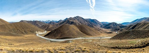 Barren mountain landscape with pass road, Lindis Pass