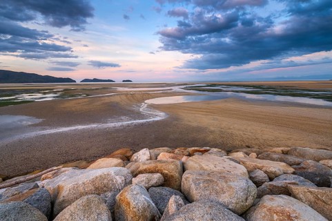 Evening mood at low tide, sand formations on the coast of Torrent Bay