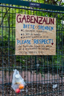 Gift fence, bag with food for the needy hangs on wire fence