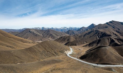 Barren mountain landscape with pass road, Lindis Pass