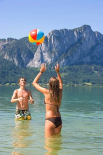 Two teenagers play with water polo in a lake, 18 years