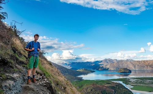 Hiker on the hiking trail to Rocky Peak, views of Wanaka Lake and mountains