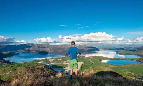 Hiker is looking out for Wanaka Lake and mountains, Rocky Peak