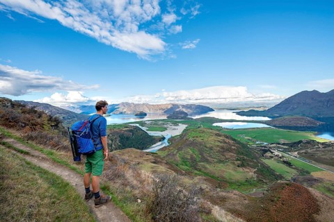 Hiker on the trail to Rocky Peak, views of Wanaka Lake and mountains