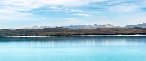 Blue glacier lake Lake Pukaki with mountain range, Mount Cook National Park