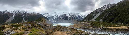 Hanging bridge over Hooker River, behind Hooker Lake and Mount Cook