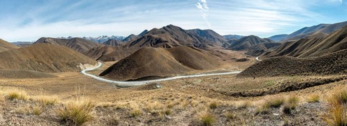 Barren mountain landscape with pass road, Lindis Pass