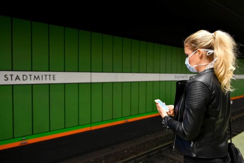 Woman with face mask, on mobile phone