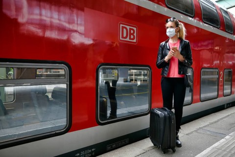 Woman with face mask, waiting for train