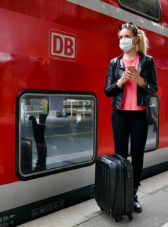 Woman with face mask, waiting for train