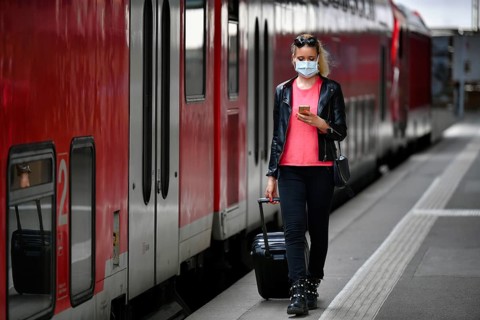 Woman with face mask, waiting for train