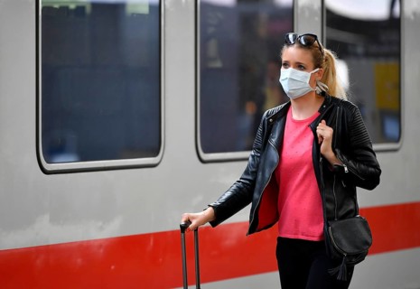 Woman with face mask, waiting for train
