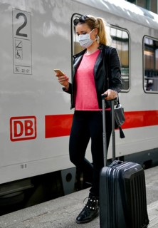 Woman with face mask, waiting for train