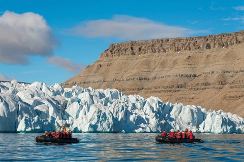 Rubber dinghies with tourists in front of glaciers, Croker Bay