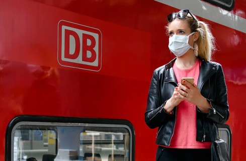 Woman with face mask, waiting for train