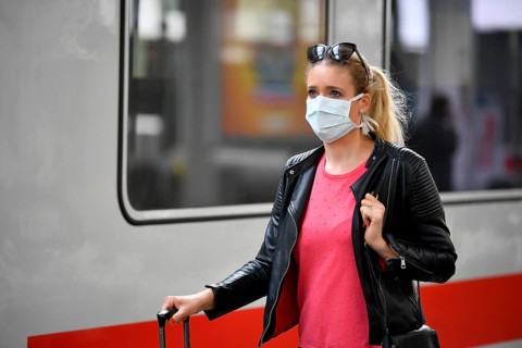 Woman with face mask, waiting for train