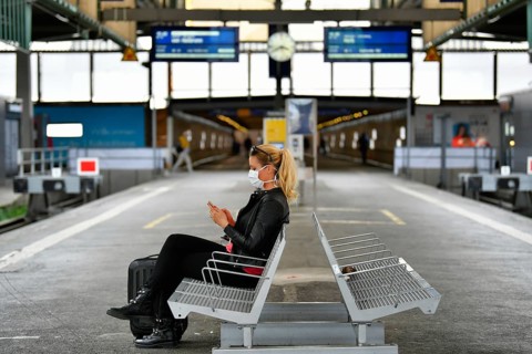 Woman with face mask, waiting for train