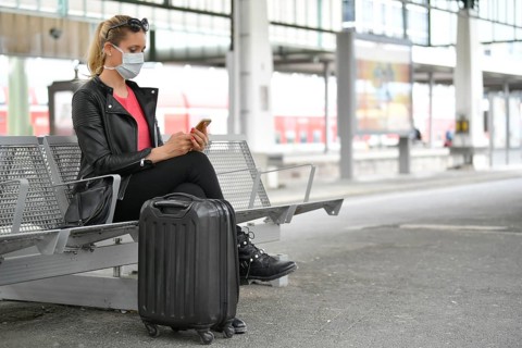 Woman with face mask, waiting for train