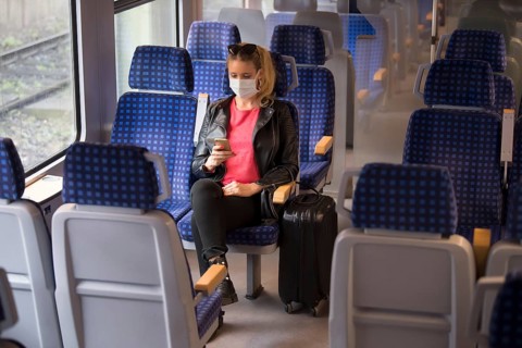 Woman with a face mask, sitting in Zug