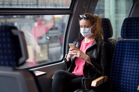 Woman with a face mask, sitting in Zug