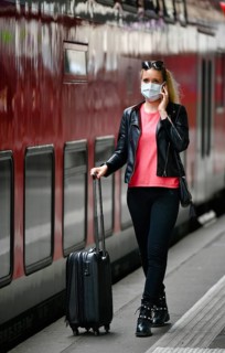 Woman with face mask, waiting for train